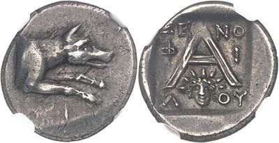 an ancient coin with a dog on it and a letter on the front