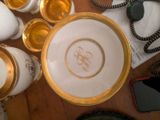 a gold plate with a monogram on it sitting on a table