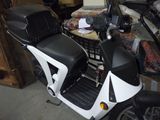 a motor scooter that is parked in a garage