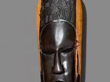 an image of a wooden mask hanging on a wall