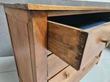 a wooden dresser with a drawer on top of it