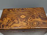 a wooden box sitting on a table next to a plate