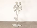 a metal sculpture of a flower on a stand