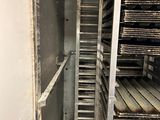 an image of a room that has a bunch of shelves in it