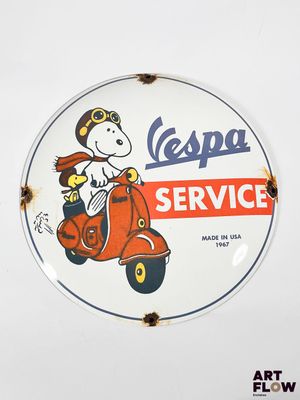 an old vespa service sign is displayed on a white wall
