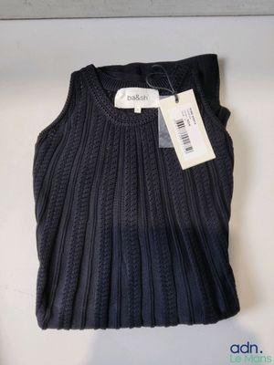 the sweater is on display on the table with a price tag
