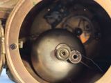 a close up of a clock with a metal ball inside of it