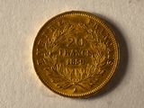 a gold coin with a wreath on it on a white surface