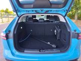 a trunk of a blue car with the back door open
