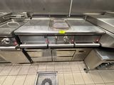 a kitchen with a lot of stainless steel appliances in it