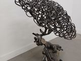 a metal sculpture of a tree with a bunch of branches on top of it