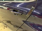 a close up of a car door handle with a sticker on it