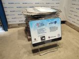 a pile of newspapers sitting on top of a metal stand