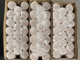 two boxes filled with plastic cups sitting on top of a table