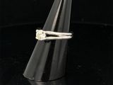 a close up of a ring with a diamond on top of a cone