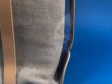 the inside of a clear bag with a brown handle on a blue background