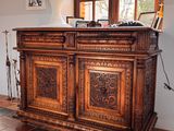a large wooden cabinet in the middle of a room