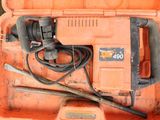an orange tool box with a hammer and other tools in it
