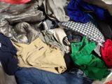 a suitcase full of clothes and a hat on the floor