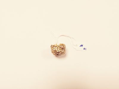 a small bead hanging from a string on a white surface