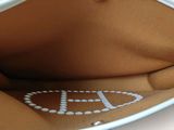 a white purse that has a logo on it