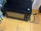 a toaster oven sitting on a tiled floor in a kitchen