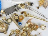 many different types of jewelry on a white table