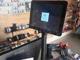 an image of a computer in a store with a lot of items on the counter