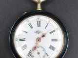 a close up of a pocket watch with roman numerals on it