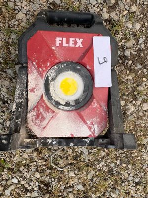 a gas can with an egg in it on the ground