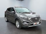 a picture of a grey car in a showroom