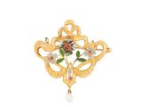 un gros plan sur une broche ornée de fleurs et de perles