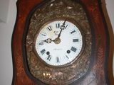 a grandfather clock with roman numerals on the face