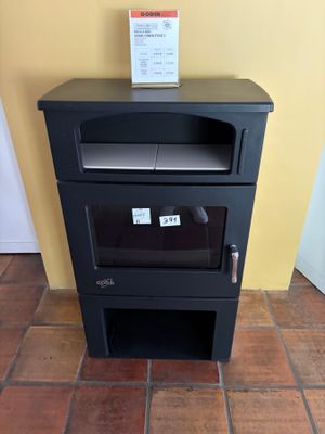 a small black stove in the corner of a room