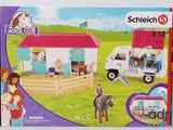 a box with a toy horse and trailer in it