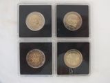four different types of gold coins in a plastic case