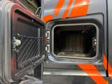 an open door of a truck that is parked in a garage