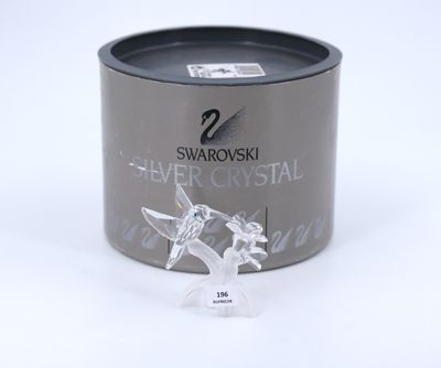 a silver crystal figurine sitting in a black container