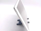 a white tablet computer sitting on a stand on a white surface
