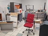 a red chair in the middle of a room