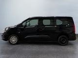 the small black van is parked in a parking lot