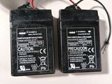 two batteries that are connected to each other on the table