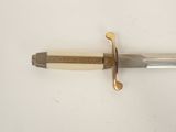 a close up of a knife with a wooden handle on a white surface