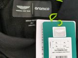 a black jacket with a green tag attached to it