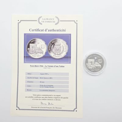 un certificat d'authenticité d'une pièce de monnaie sur laquelle figure l'image d'un train