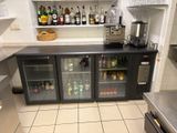 many bottles of alcohol on the shelves in the kitchen
