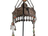 an image of a silver and turquoise beaded hat on a stand