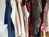 a lot of clothes hanging on a rack in a room