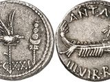 a silver coin with an image of a bird on it