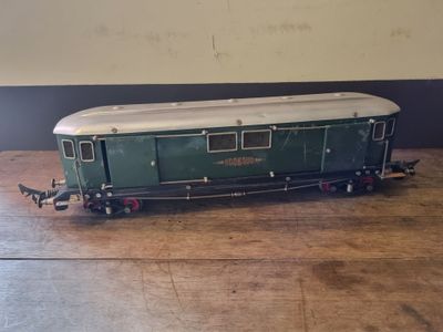 a green and white train car on a wooden table